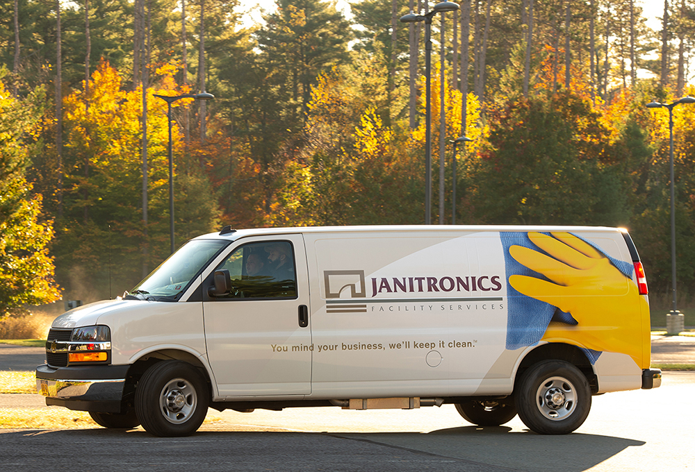 Janitronics van in front of trees in the fall