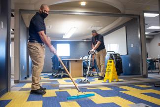 Professional carpet cleaning in an office wearing masks 