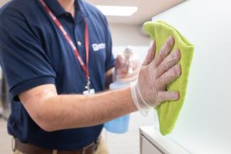 Janitronics technician cleaning workspaces