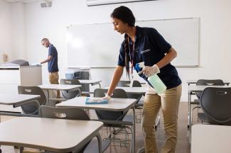 Janitronics employees cleaning an academic classroom