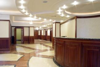 A bright lobby space with shiny red, cream, and black marble floors.