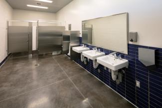 A public restroom with tiled walls that have been given a deep clean