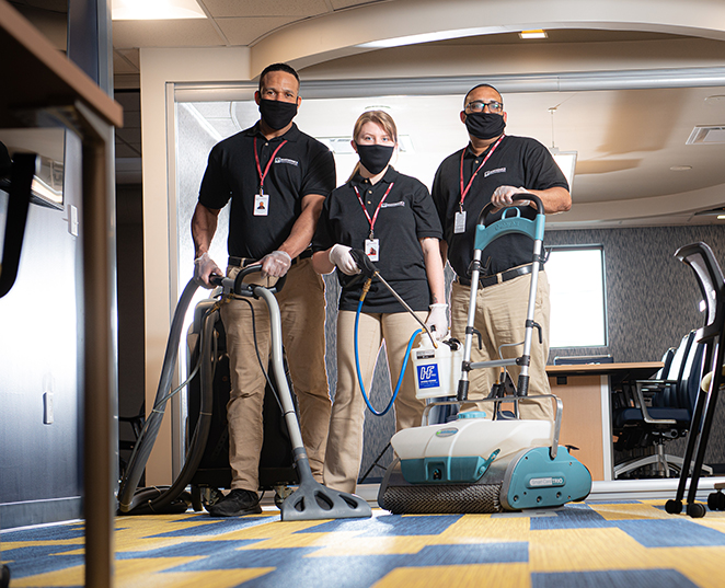 three Janintronics cleaning technicians standing with their cleaning equipment
