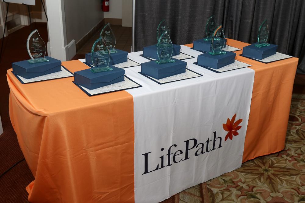 LifePath's Third Age Achievement Award glass awards displayed on a table