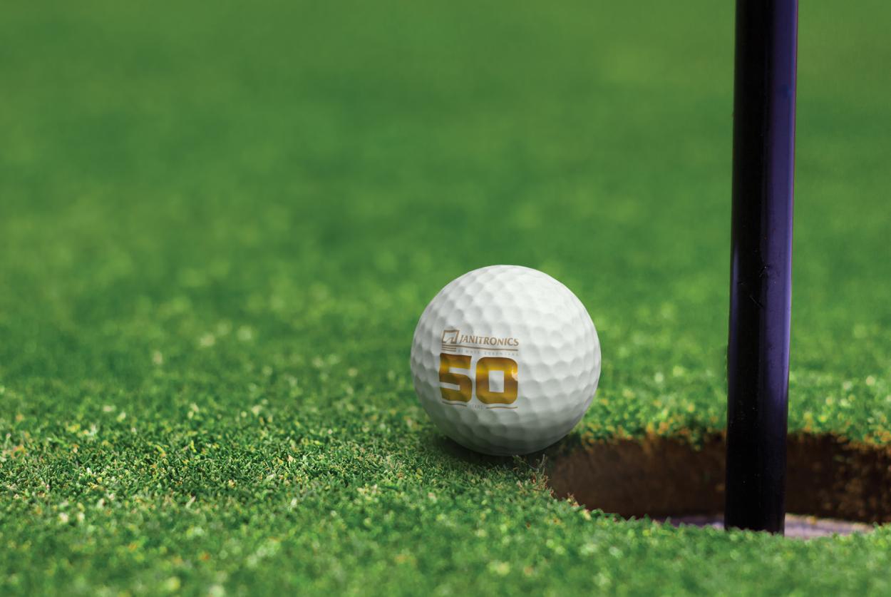 golf ball with the Janitronics logo about to fall into the the golf cup