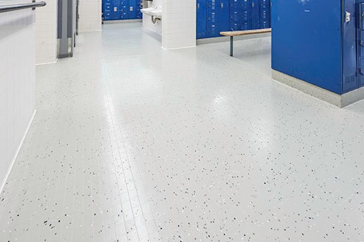 Tiled floor in a locker room after hard surface restoration
